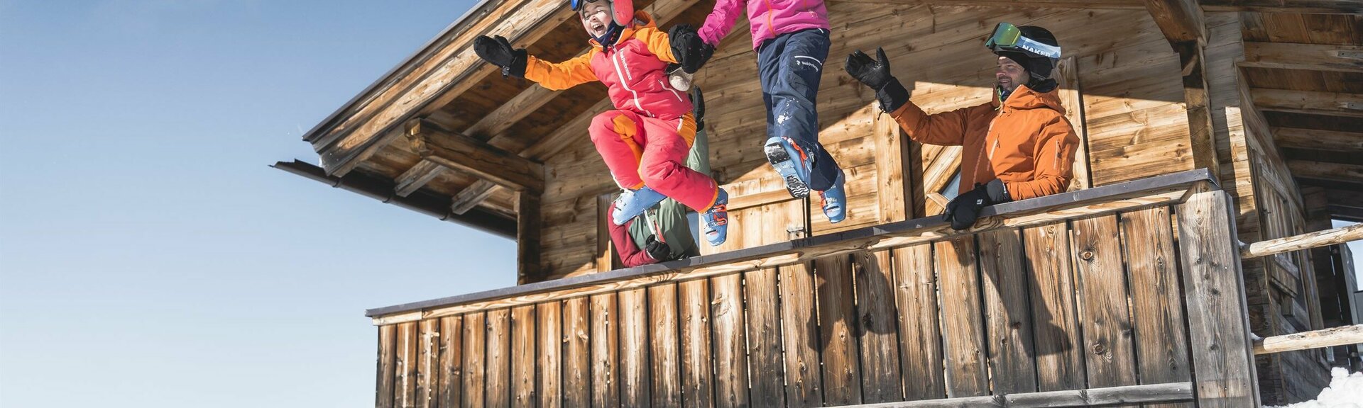 Familie in Skiausrüstung auf Berghütte
